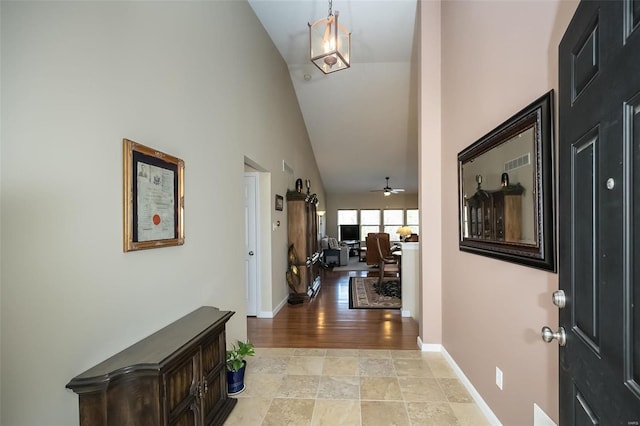 entryway with high vaulted ceiling, baseboards, and a ceiling fan