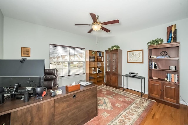 home office featuring wood finished floors and ceiling fan