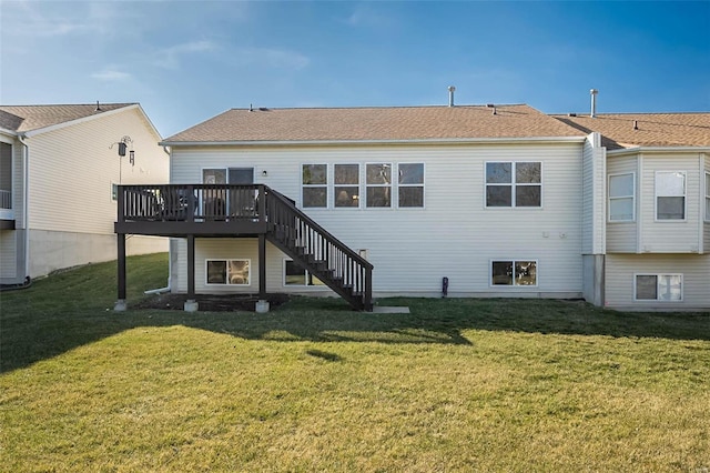 back of property with a lawn, a wooden deck, and stairs