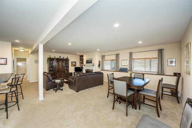 dining area with recessed lighting, light colored carpet, and baseboards