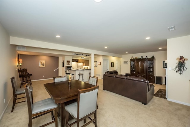 dining space featuring light carpet, visible vents, and recessed lighting