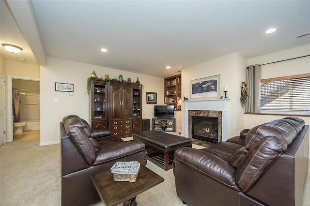 living room featuring a fireplace, recessed lighting, light colored carpet, and visible vents