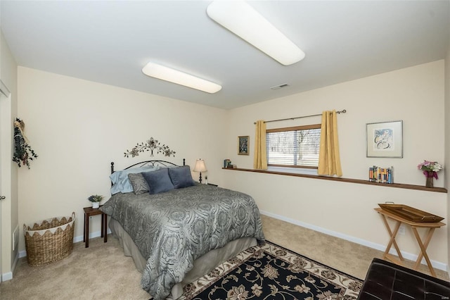 carpeted bedroom with visible vents and baseboards