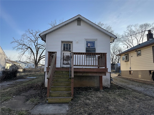 rear view of property featuring stairway and a wooden deck