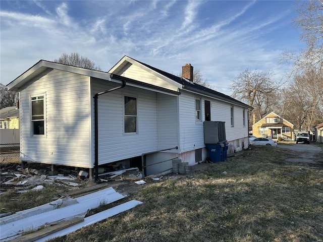 view of side of home featuring a chimney