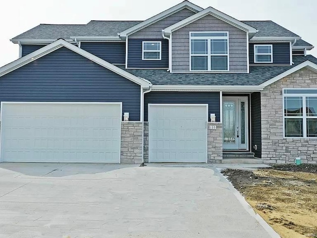 craftsman-style home featuring stone siding, a garage, and driveway