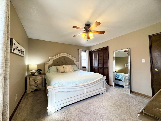 carpeted bedroom featuring a ceiling fan, baseboards, and a closet