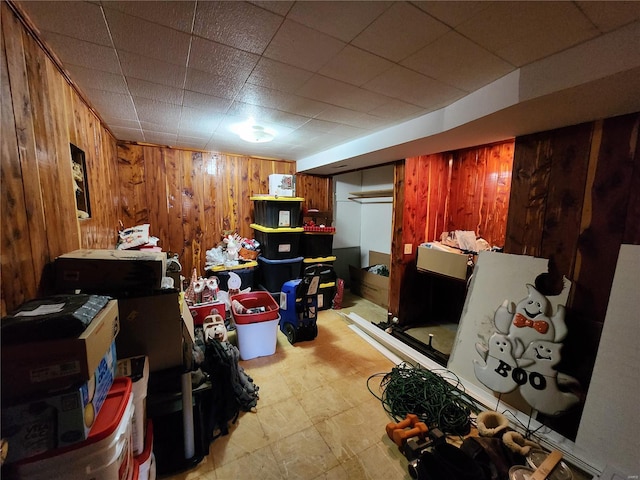 finished basement featuring light floors and wooden walls