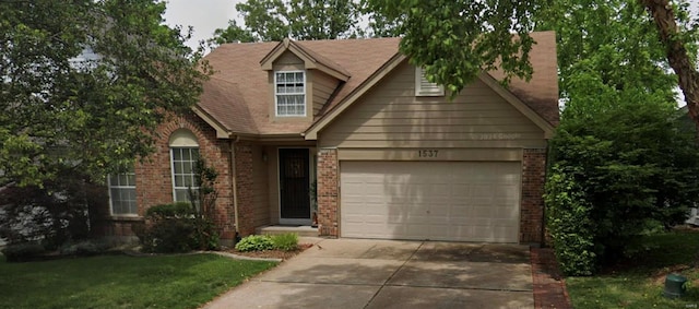 view of front of home with driveway, a garage, and brick siding