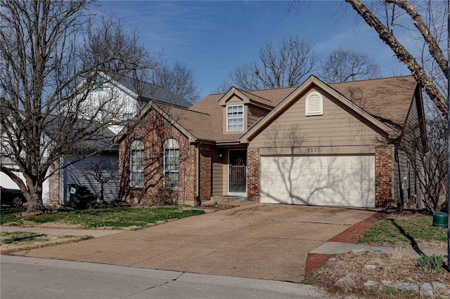 view of front of property featuring concrete driveway, a garage, brick siding, and a shingled roof