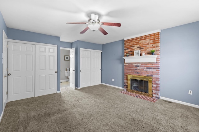 unfurnished living room featuring carpet flooring, baseboards, a ceiling fan, and a fireplace