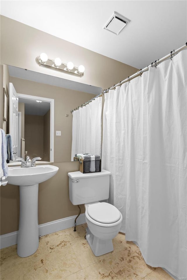 bathroom with tile patterned floors, visible vents, toilet, and baseboards