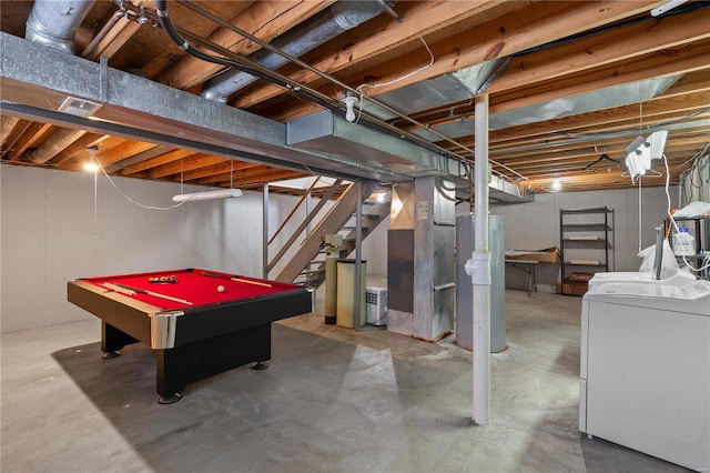 unfinished basement featuring stairway, water heater, and washer and clothes dryer