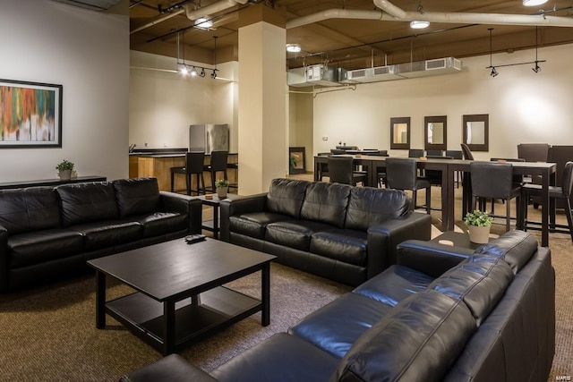 living room with a high ceiling and carpet flooring