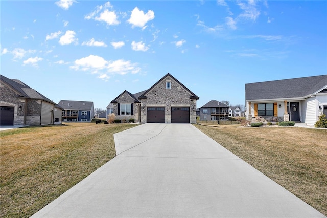 view of front of house featuring a garage, concrete driveway, a front yard, and stone siding