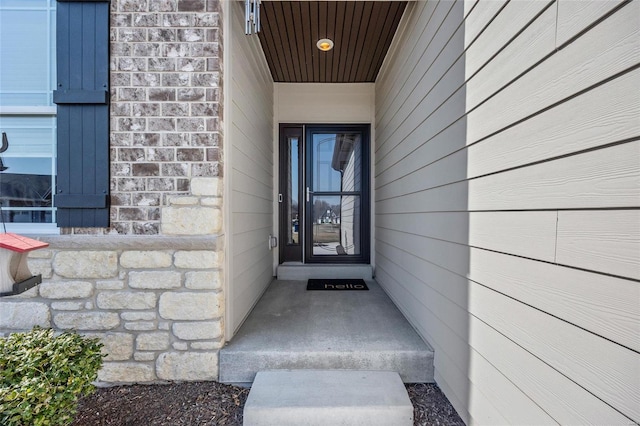 doorway to property with stone siding