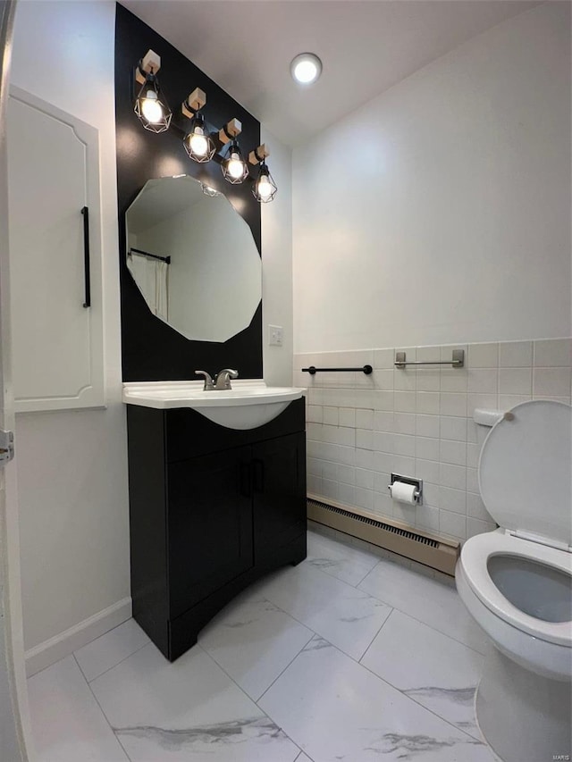 bathroom with vanity, a baseboard radiator, tile walls, toilet, and marble finish floor