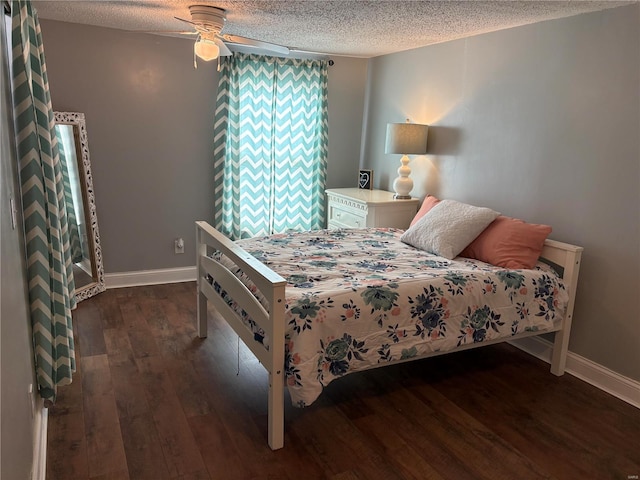 bedroom featuring ceiling fan, a textured ceiling, baseboards, and hardwood / wood-style flooring