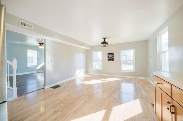 interior space with visible vents, baseboards, and light wood-style floors