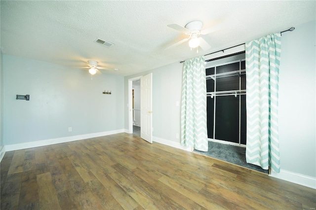 unfurnished room featuring visible vents, baseboards, ceiling fan, a textured ceiling, and wood-type flooring