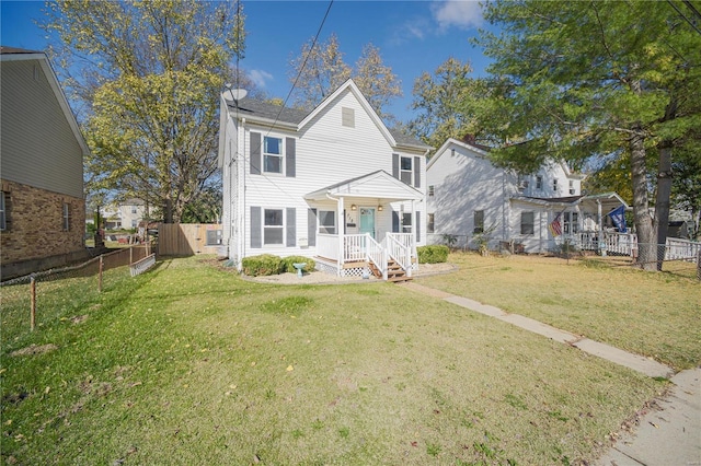 view of front of property featuring a porch, fence private yard, and a front lawn