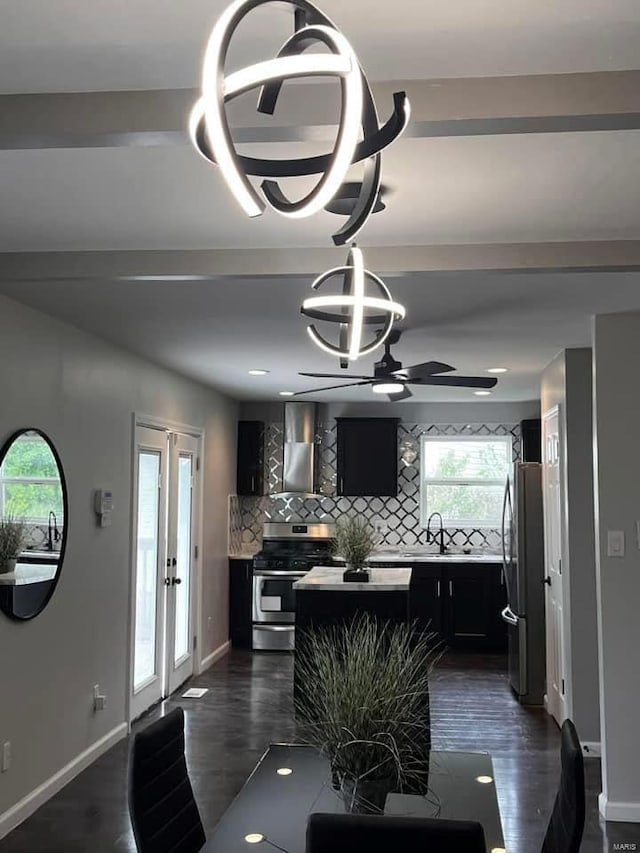 dining area with dark wood-style floors, ceiling fan with notable chandelier, baseboards, and french doors