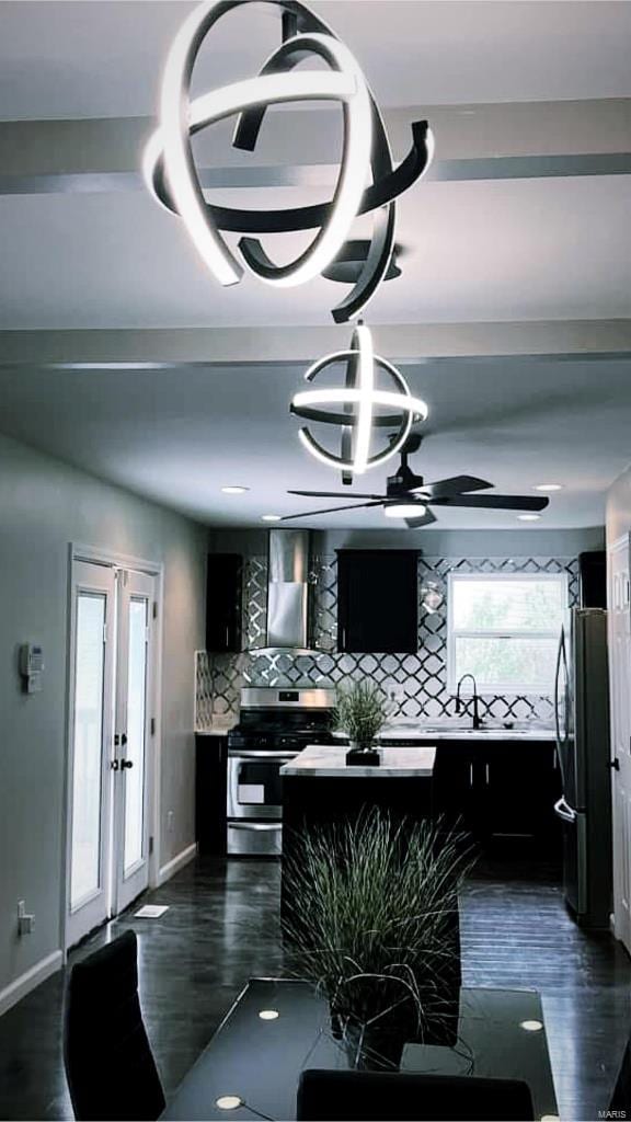 interior space featuring ceiling fan with notable chandelier, dark wood-style flooring, french doors, and baseboards