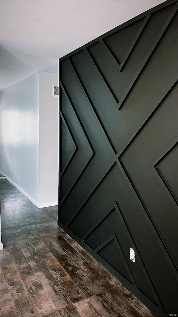 interior details featuring visible vents, baseboards, and wood finished floors