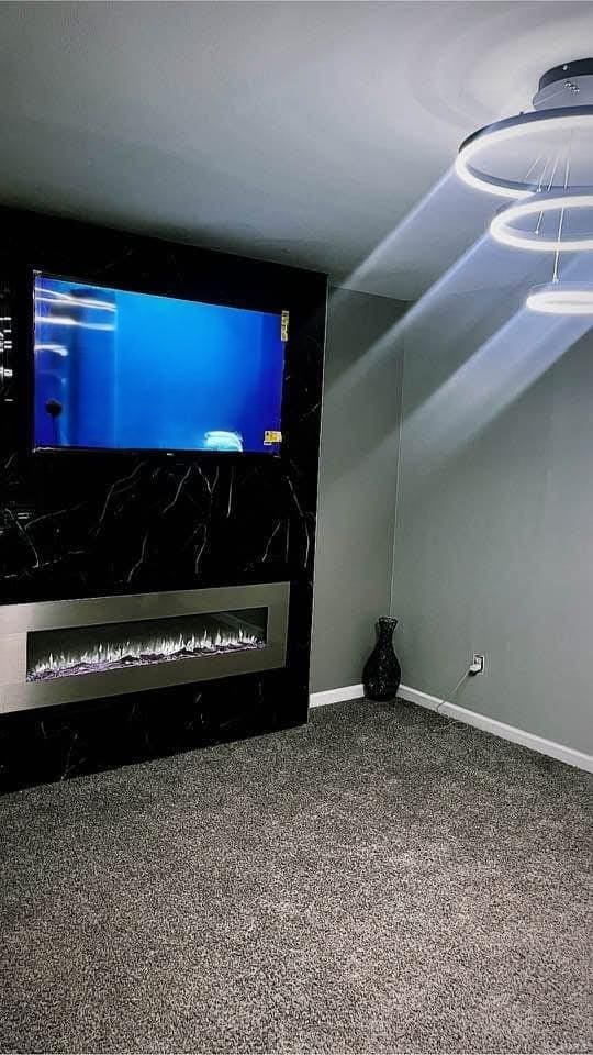 unfurnished living room featuring vaulted ceiling and baseboards