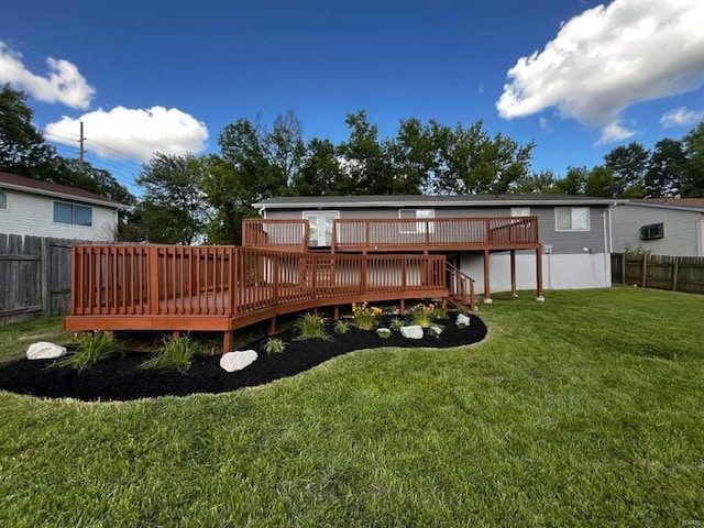 back of house featuring a lawn, a deck, and fence