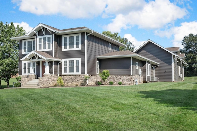 view of front of property featuring a front lawn and stone siding