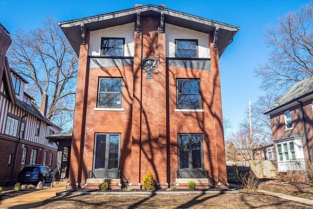 rear view of property featuring brick siding