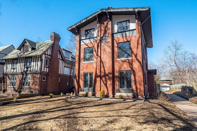 view of front of property featuring brick siding and driveway