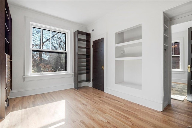 interior space with wood finished floors and baseboards