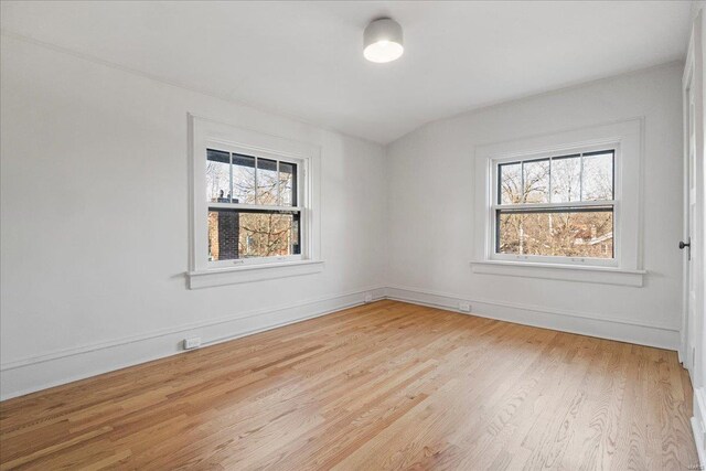 empty room featuring baseboards and light wood-type flooring