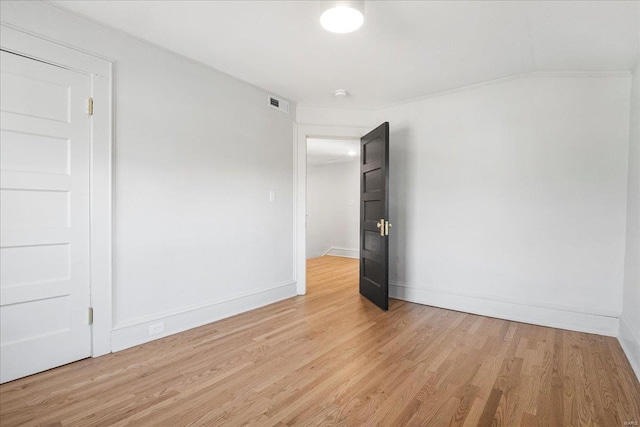 unfurnished room with visible vents, baseboards, and light wood finished floors