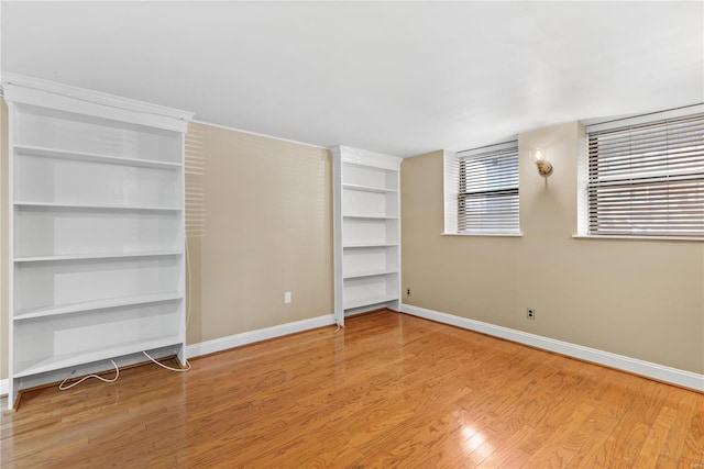 unfurnished bedroom with baseboards and wood finished floors