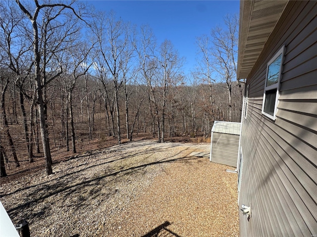 view of yard featuring a wooded view