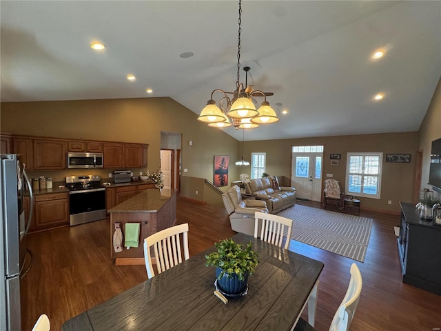 dining room with dark wood-style flooring, vaulted ceiling, baseboards, and an inviting chandelier