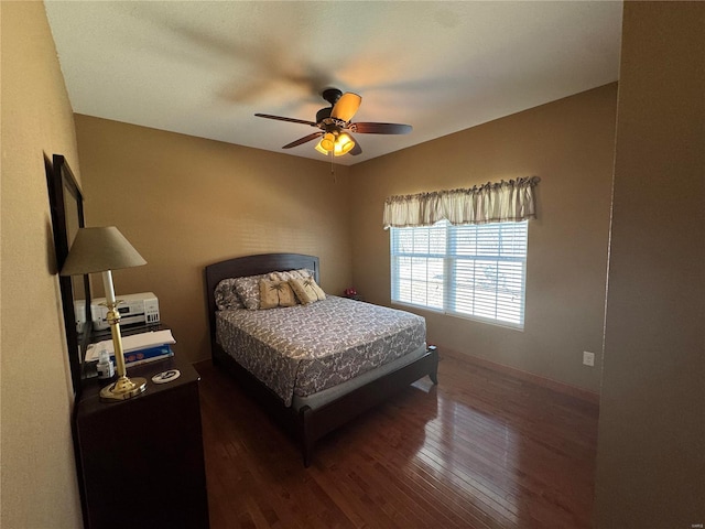 bedroom with wood-type flooring and a ceiling fan