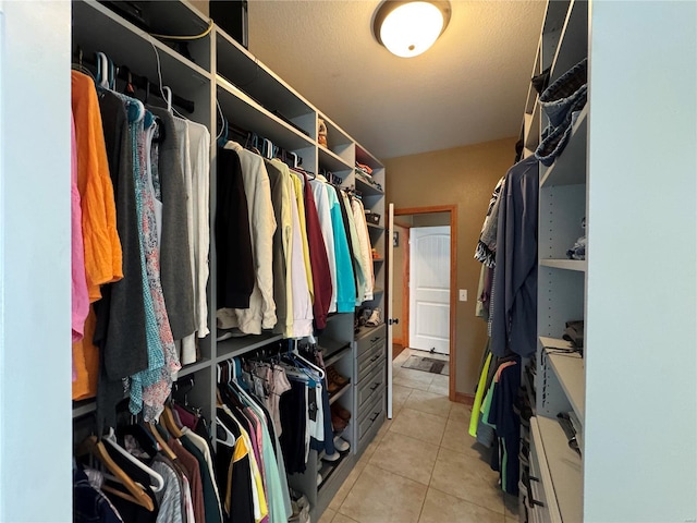 spacious closet with light tile patterned flooring