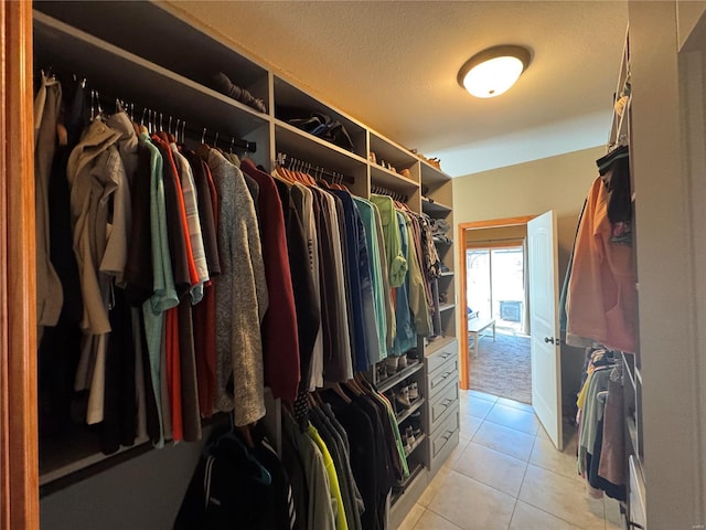 spacious closet featuring light tile patterned floors