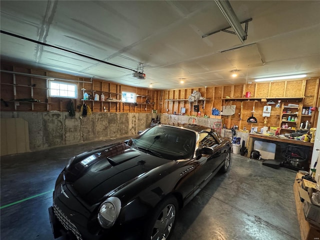 garage with a workshop area and a garage door opener