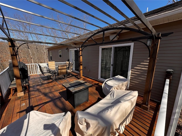 wooden terrace with an outdoor hangout area, outdoor dining area, and a pergola