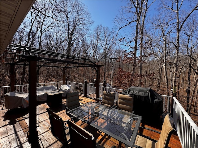 wooden terrace featuring outdoor dining space, grilling area, and a pergola