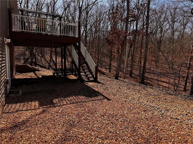 view of yard with stairs and a deck