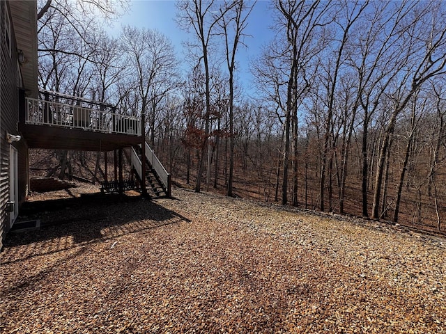 view of yard featuring a deck and stairs