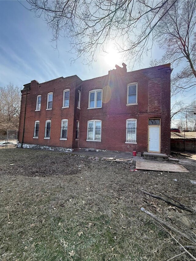 rear view of property featuring brick siding