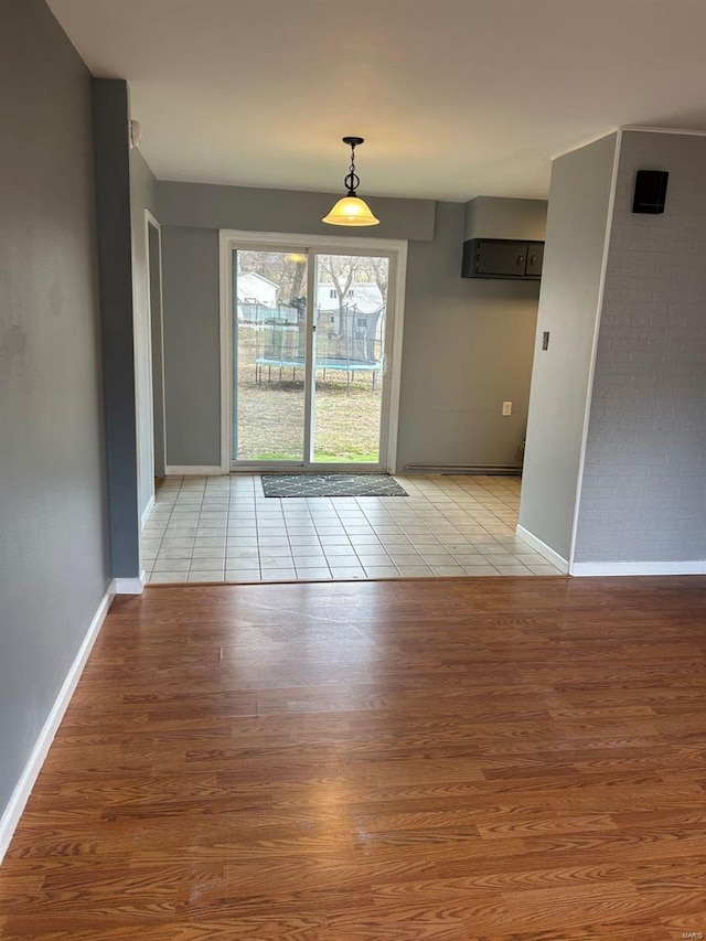 interior space featuring light wood finished floors and baseboards