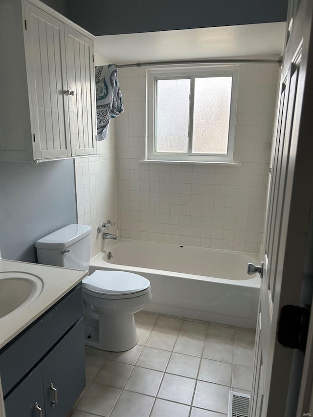 full bath featuring tile patterned floors, visible vents, toilet, washtub / shower combination, and vanity